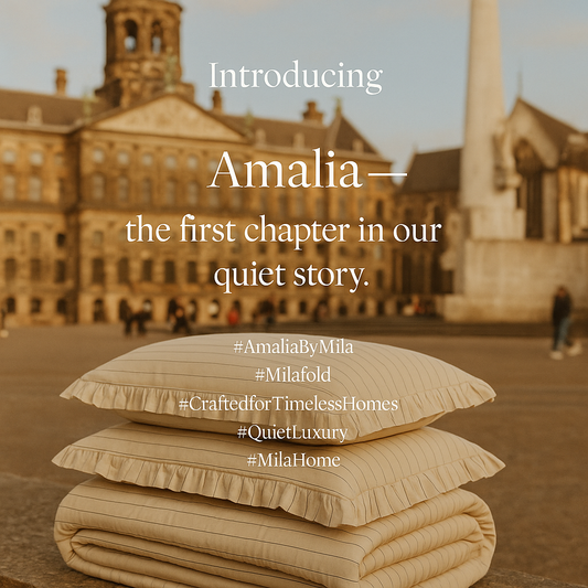Stack of beige striped pillows and blanket with historic building backdrop and text introducing Amalia home collection