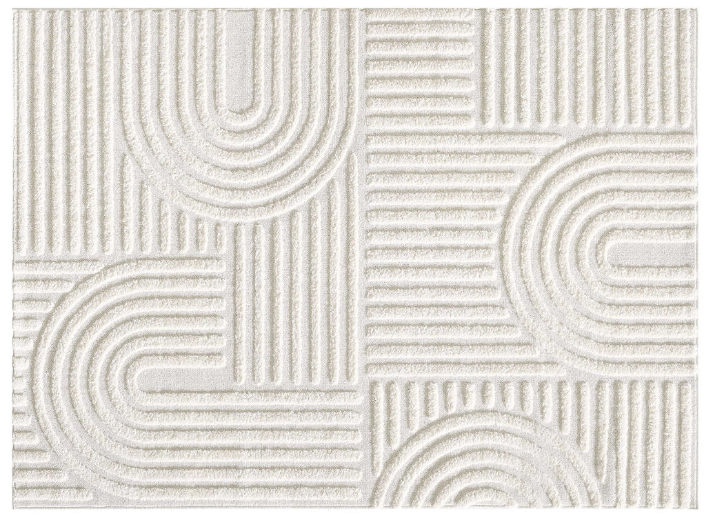 Close-up of a white textured rug with a geometric pattern of raised arcs and parallel lines