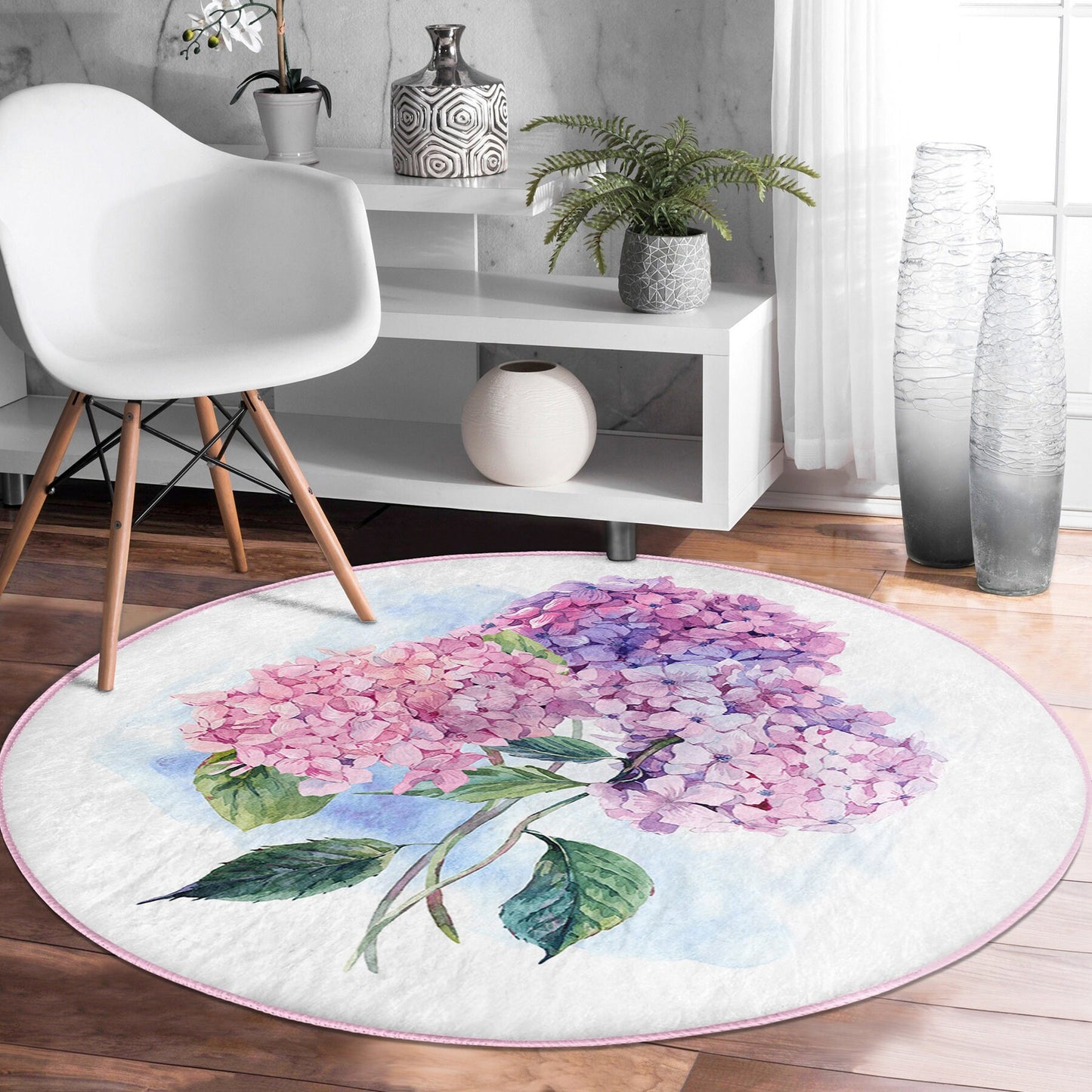 Round floral rug with pink and purple hydrangea design on wooden floor in modern room
