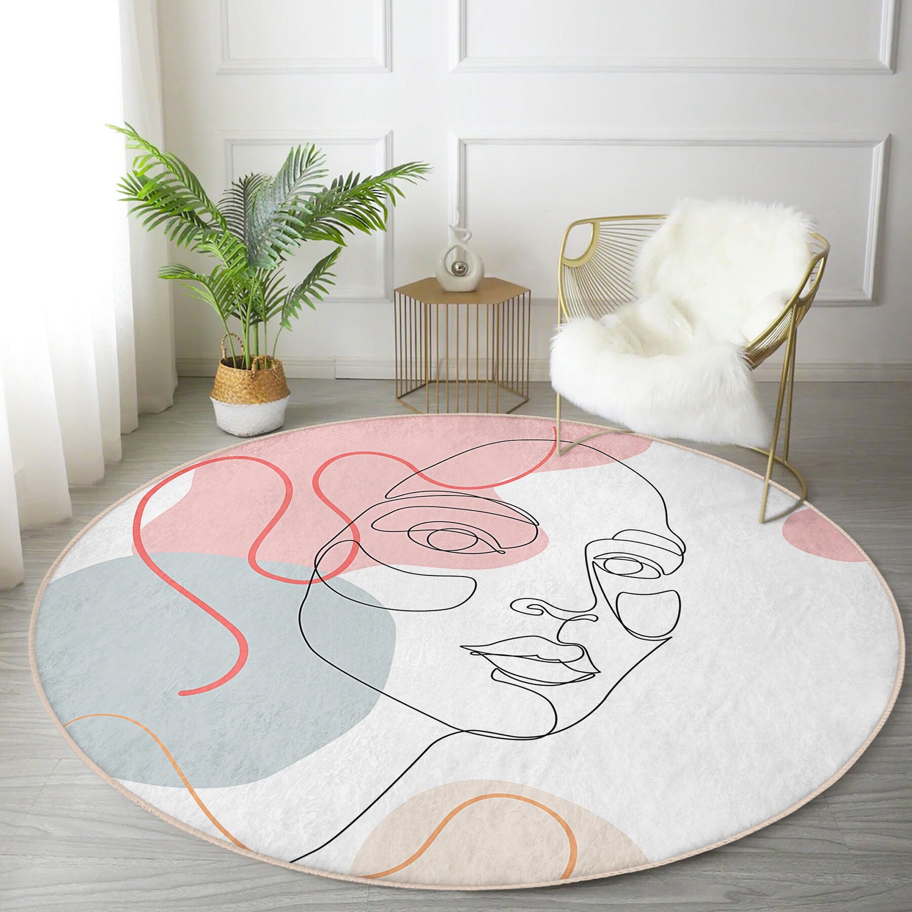 Modern living room with round abstract face art rug, gold wire chair with white fur throw, green potted plant