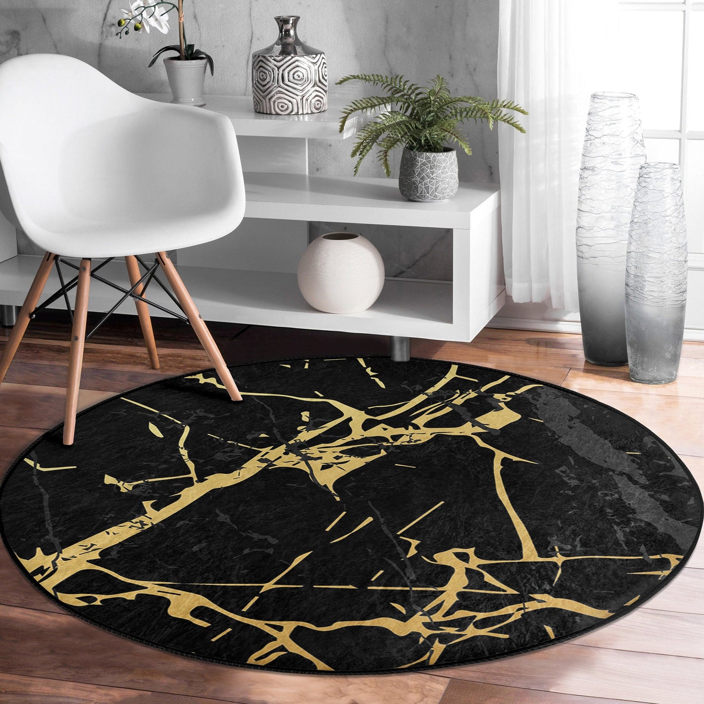 Modern interior with white chair, white shelf, decorative vases, fern plant, and black round rug with gold marble pattern