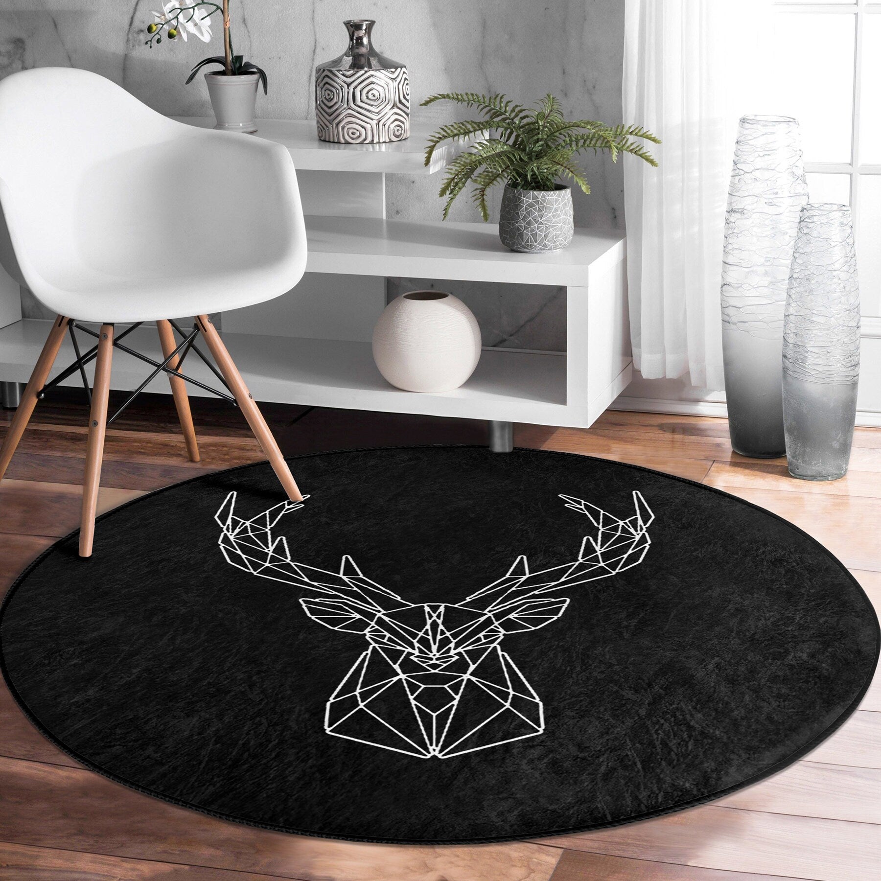 Modern white chair on dark round rug with geometric deer head design in stylish living room