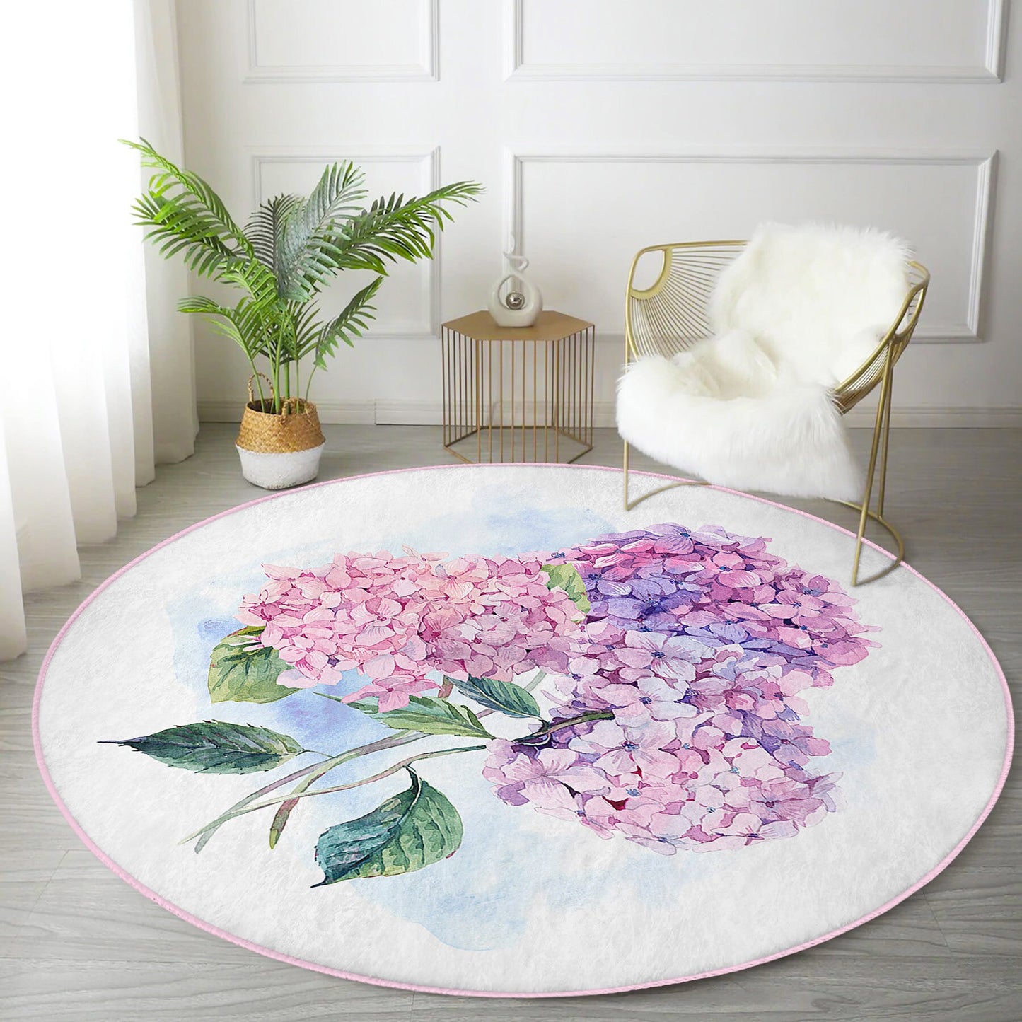 Round floral rug with pink and purple hydrangea design in modern living room with plant and gold chair