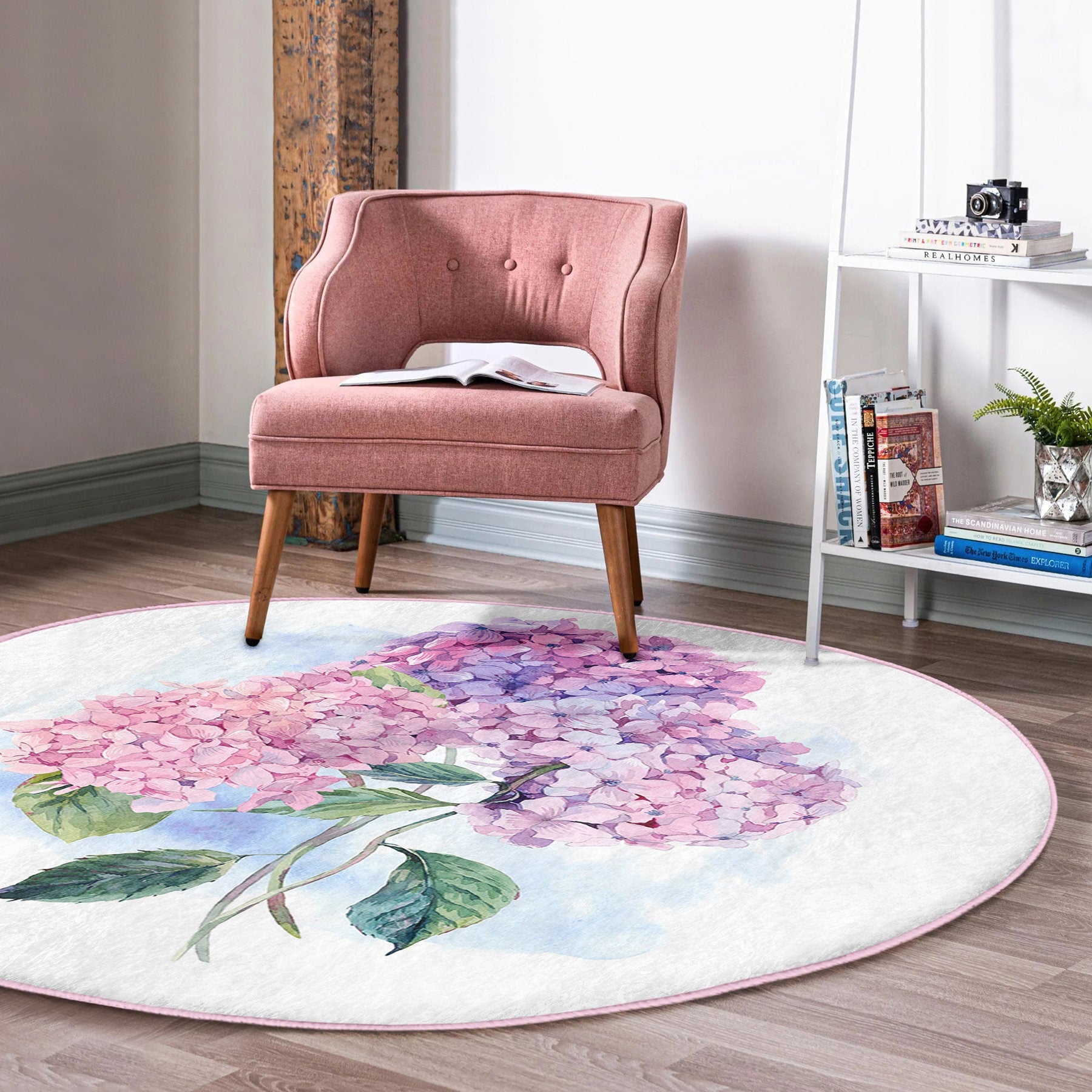 Modern pink upholstered chair on round floral hydrangea print rug in cozy reading nook