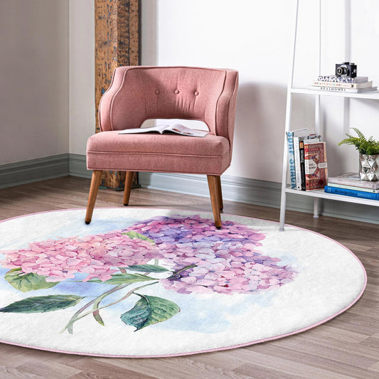Modern pink upholstered chair on round floral hydrangea print rug in cozy reading nook
