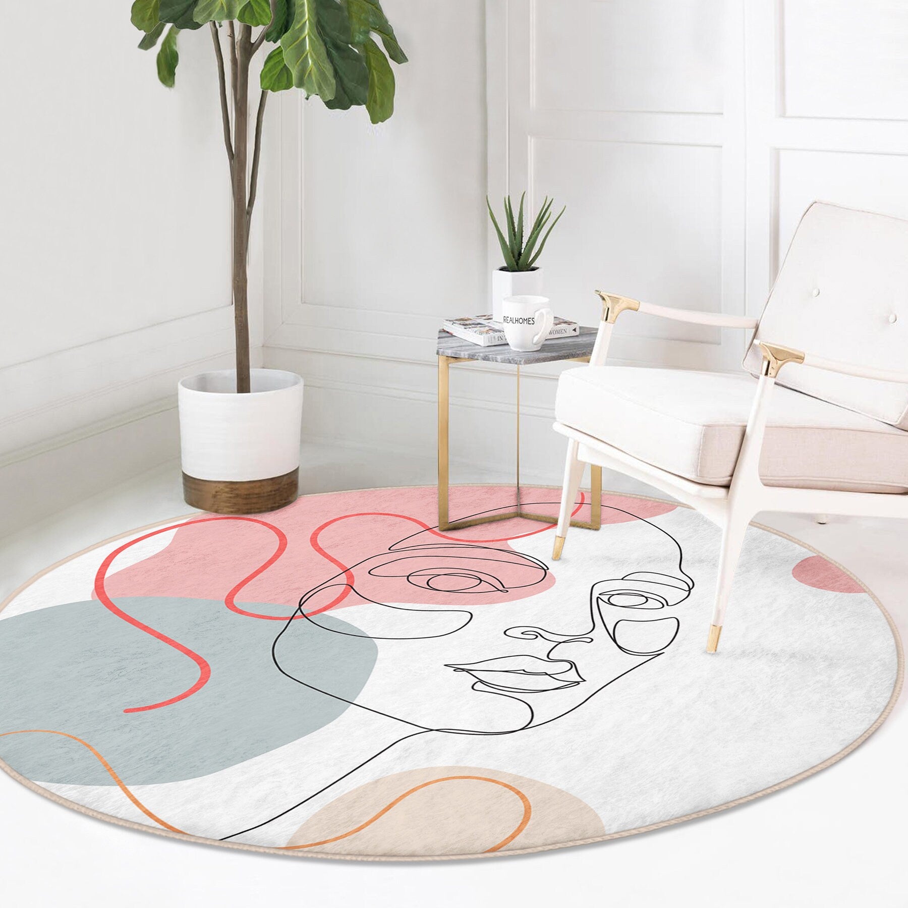 Round modern area rug with abstract female face line art in pink, blue, and beige tones in stylish living room